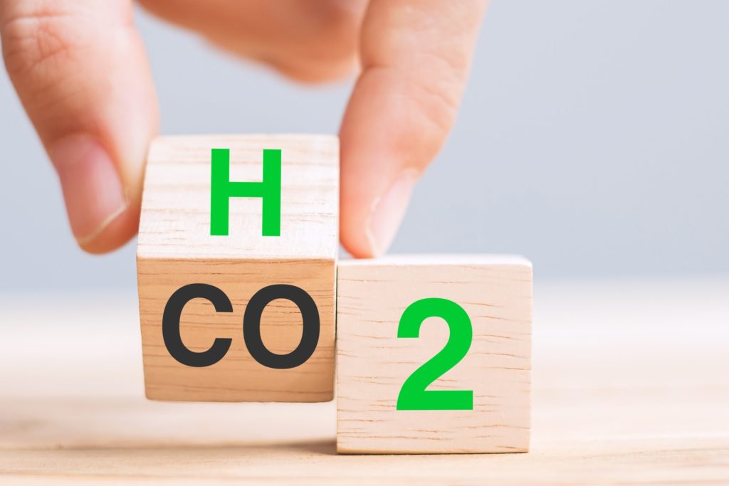 hand flipping blocks with CO2 (Carbon dioxide), change to H2 (Hydrogen) text. Free Carbon concepts